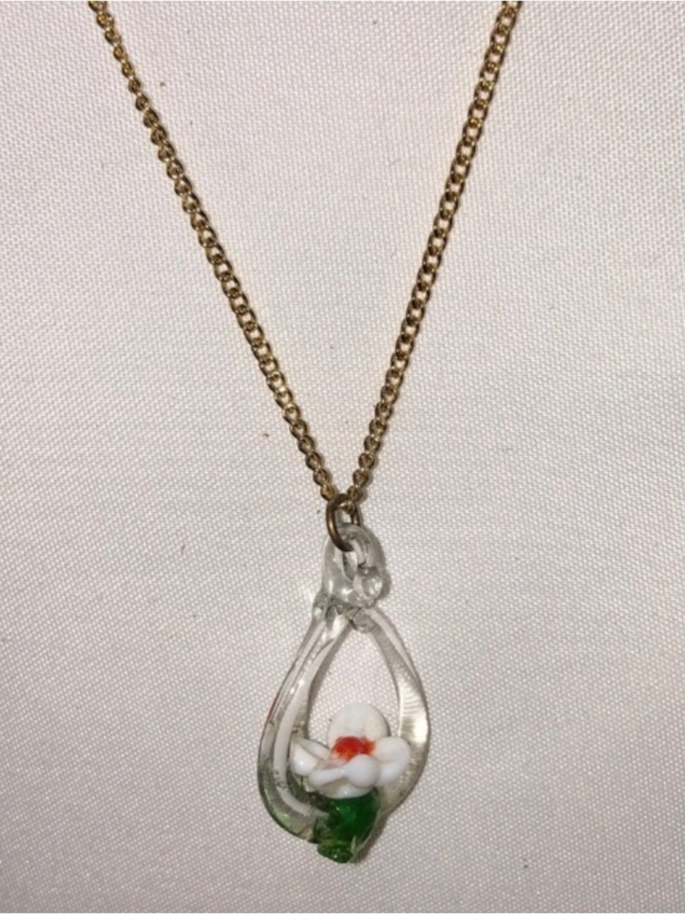 Vintage teardrop glass pendant necklace with a small floral motif